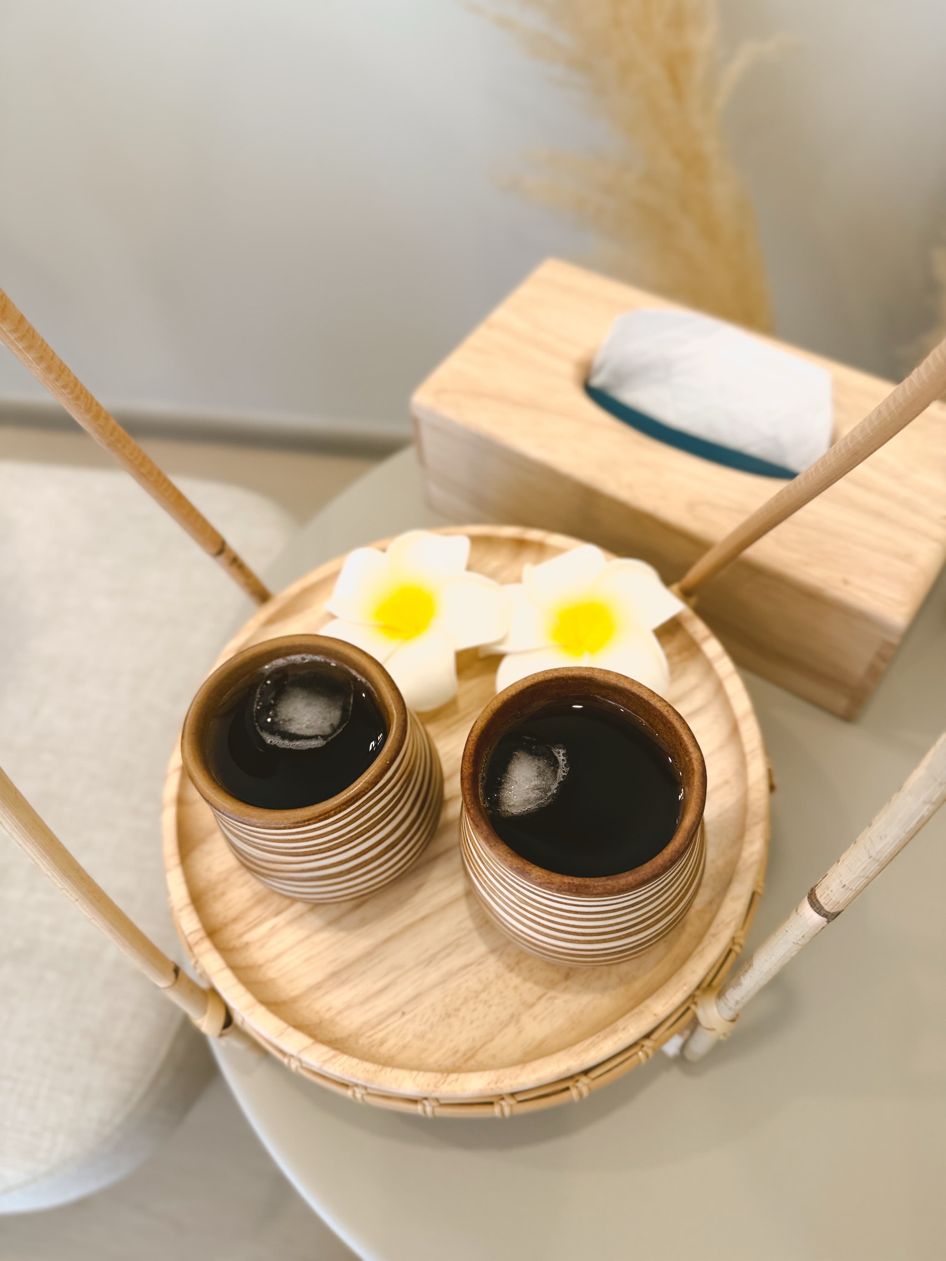 Two cups of herbal tea on a wooden tray